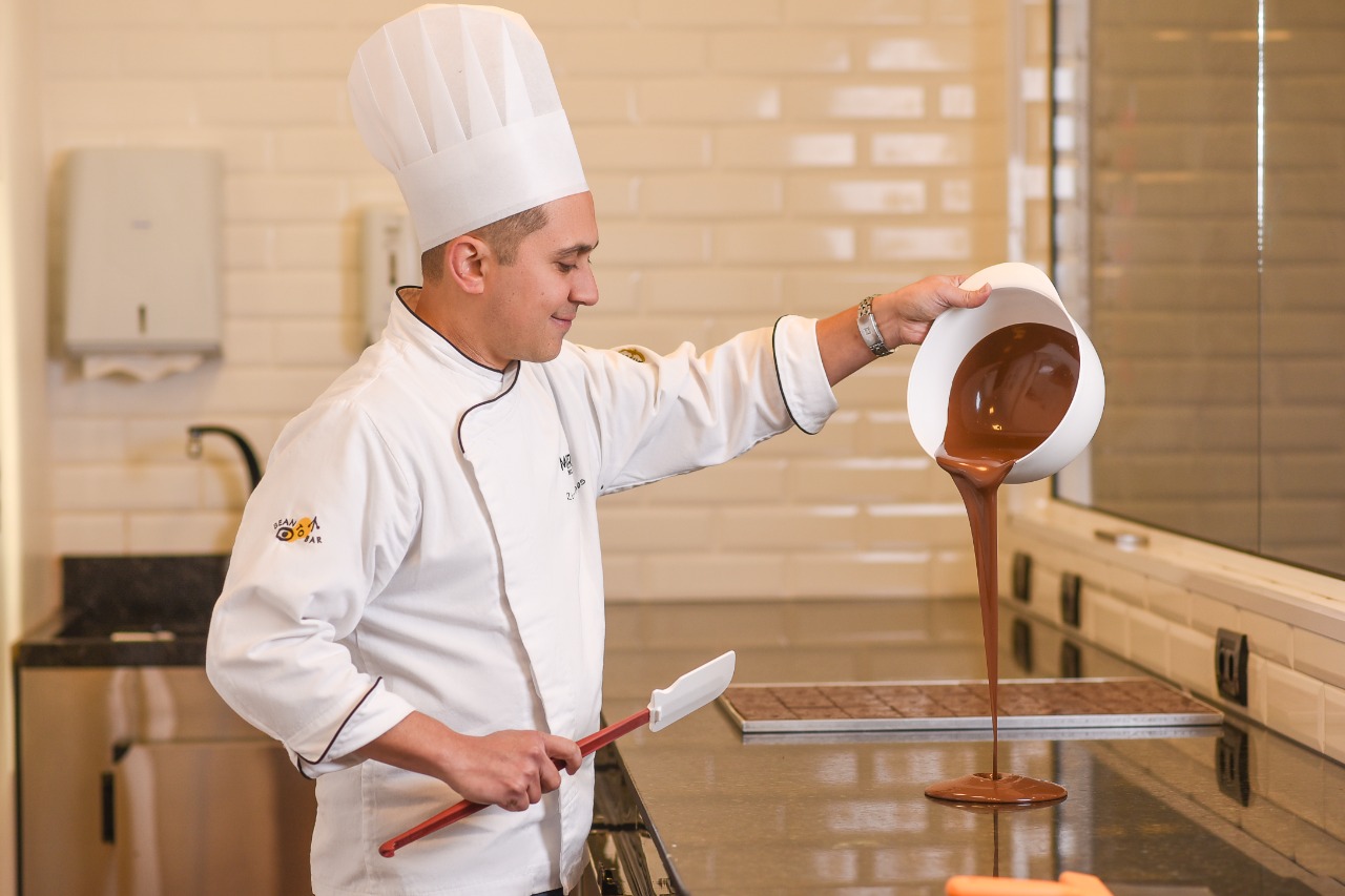 Miroh Chef pouring liquid chocolate onto marble table